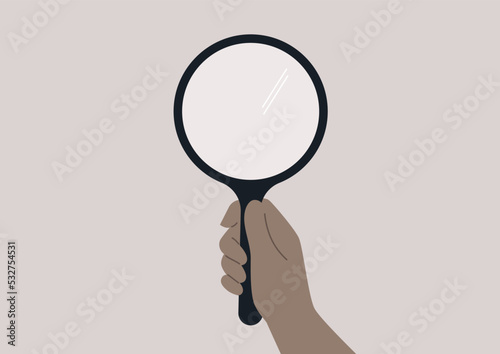 A hand holding a blank hand mirror or a magnifier