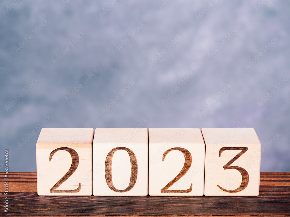Text 2023 on wooden cubes as motivation and new strategies concept Text 2023 on wooden cubes as motivation and new strategies concept