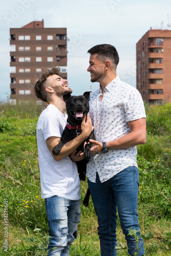 top view of a happy homosexual couple in the countryside kissing hugging and sharing moments of couple love.  photo