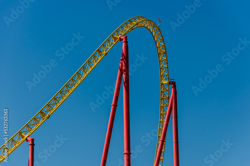 Roller coaster against the blue sky. Amusement park with attractions