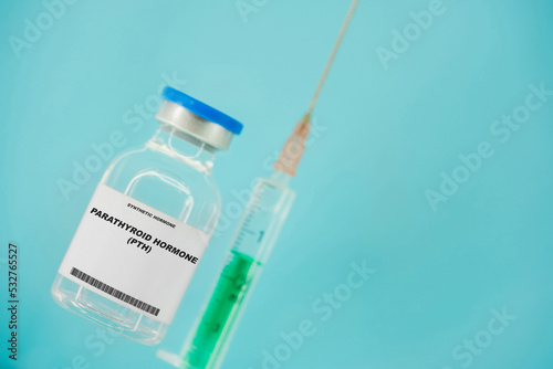 Parathyroid hormone (PTH). Test tube with artificial hormone on pink background Parathyroid hormone (PTH) photo