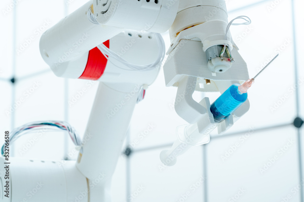 Robot hand with a medical syringe. Future medicine concept using robots and artificial intelligence
