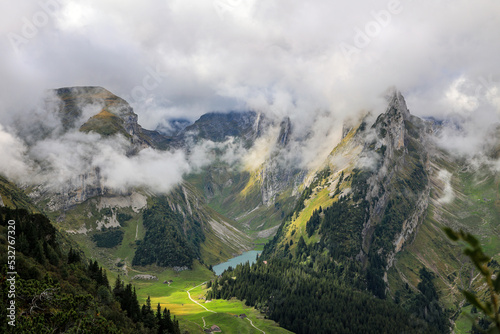 Morming sun light and moving mist on the rocky over the the Fälensee in the Saxerluecke, Alpstein mountains  photo