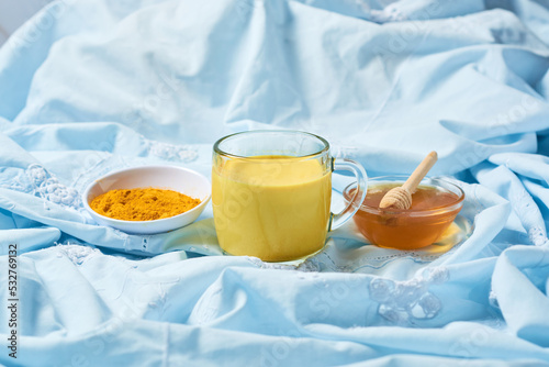 Traditional indian drink turmeric curcuma golden milk with ingredients photo