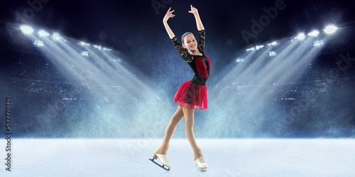 Grace. Little felae figure skater wearing beautiful dress performing short program over ice arena background. Dance, winter sports, achievements, champion concept © master1305