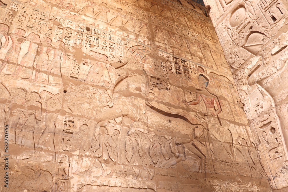 The Pharaoh at war: king Ramses III riding his war chariot (carvings at Medinet Habu temple in Luxor)