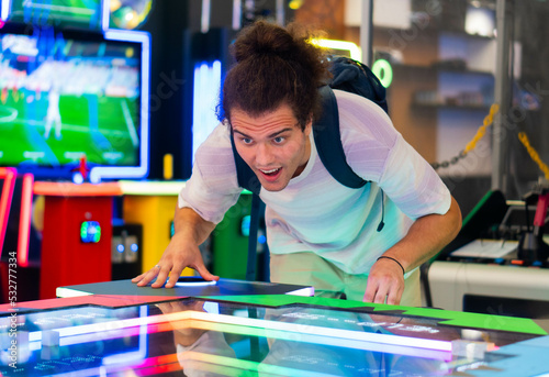 Young boy having fun at arcade centre.