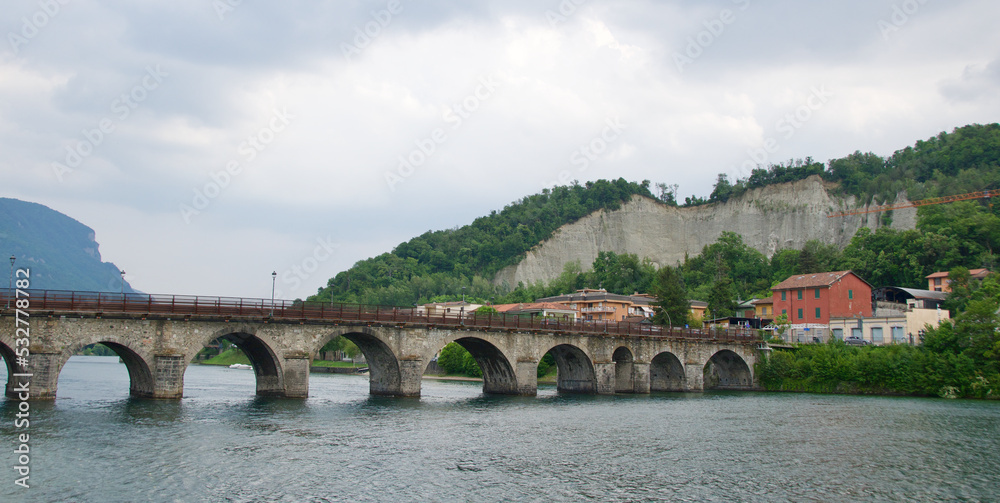 Fototapeta premium Medieval bridge across River Adda in Lake Como, Italy