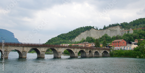 Medieval bridge across River Adda in Lake Como, Italy photo