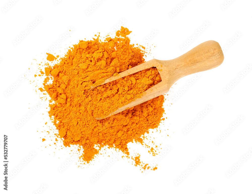 Wooden scoop full of yellow turmeric powder