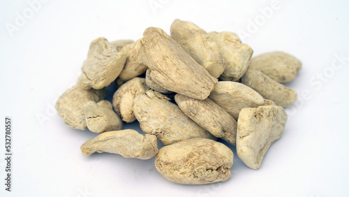 Heap of dried ginger roots on white background. Dried Organic Ginger or Dry Adrak also known as Sonth in India photo