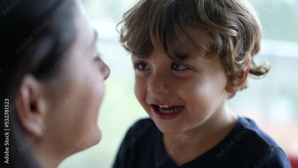 Little boy playing with mother cheeks. Closeup small boy face closeup smiling and laughing. Playful blond male kid Little boy playing with mother cheeks. Closeup small boy face closeup smiling and laughing. Playful blond male kid