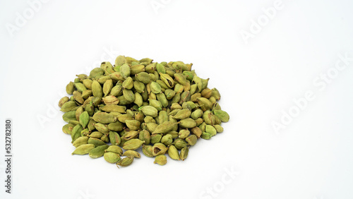 Cardamom pods and seeds isolated on white background. Green cardamom pods isolated on white background with copy space for text or images. Spices, food, cooking concept. Close-up shot.