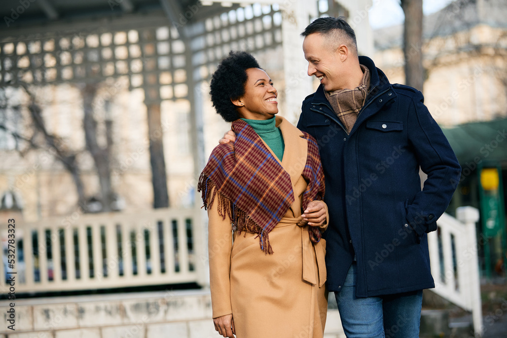 Fototapeta premium Happy couple in love talk while walking through park on winter day.