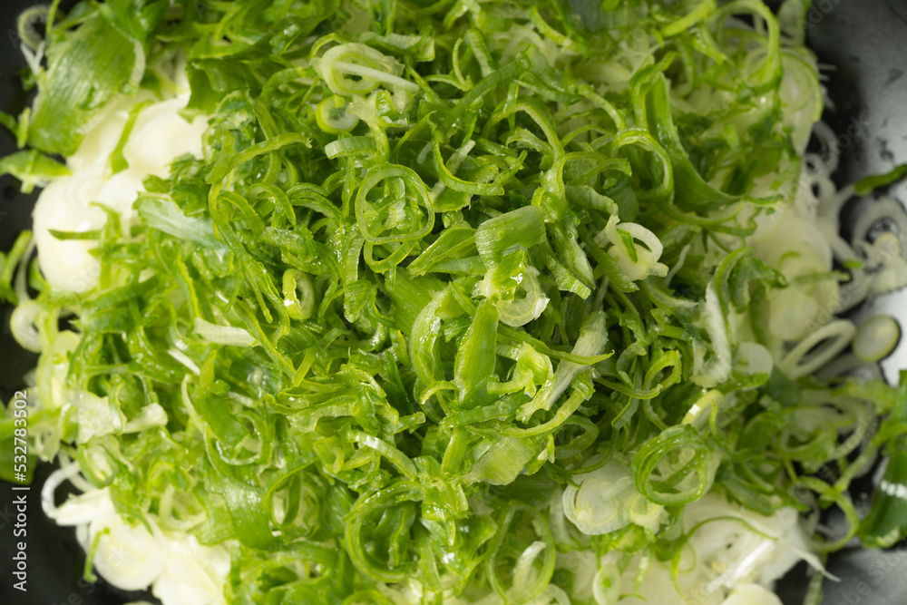 Fresh chopped green onion on dark background Fresh chopped green onion on dark background