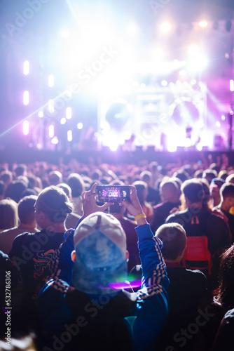 Wallpaper Mural Using a smartphone in a public event, live music festival. Technologies, party, lifestyle. Torontodigital.ca