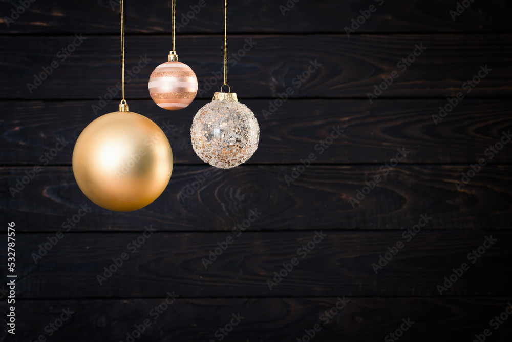 Christmas balls hanging on dark wooden background Christmas balls hanging on dark wooden background