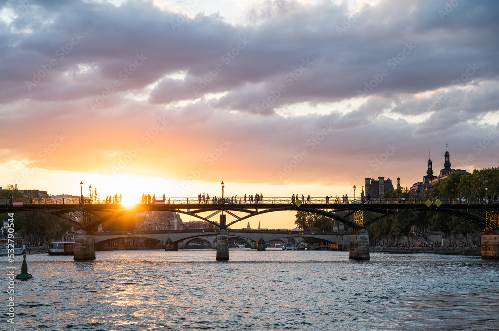 Sunset at Pont des Arts, Paris, France or Passerelle des Arts is a pedestrian bridge that has an international reputation as the bridge of romance.