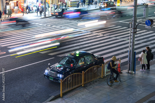 夜の東京　タクシーと車の光跡　Parked taxi cab and traffic light trails on street at night in Tokyo, Japan photo