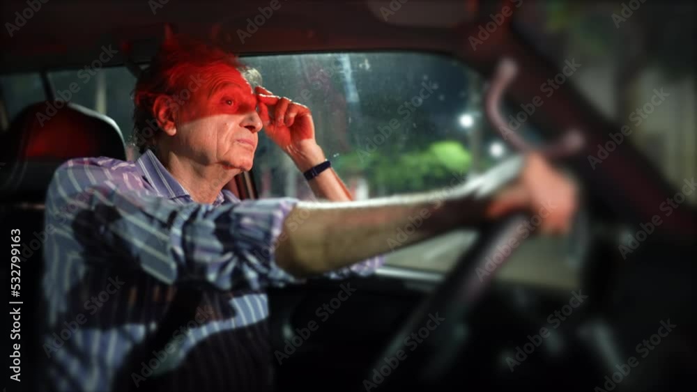 Pensive older man waiting in red light at night holding car steering wheel. Thoughtful senior person waits in signal