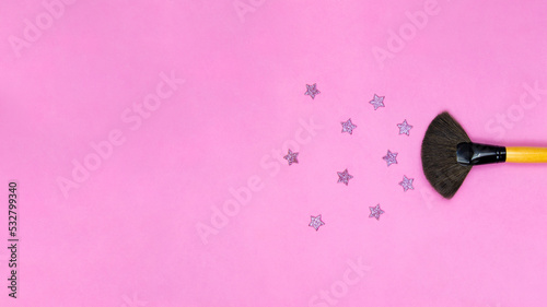 makeup brush on a pink background with a place for an inscription. banner  © Kateryna