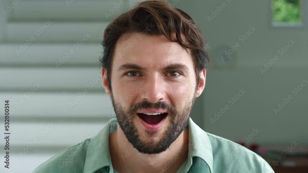 Main focus on facial expressions of a young dark-haired handsome bearded multi-ethnic man, looking at the camera, expressing surprise, astonishment, excitement and stupefaction. Slow motion