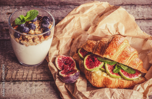 Obraz na płótnie Delicious beautiful breakfast. Croissant with figs and yogurt with berries w salonie