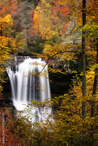 Dry Falls waterfall in North Carolina surrounded by a beautiful autumn forest. 