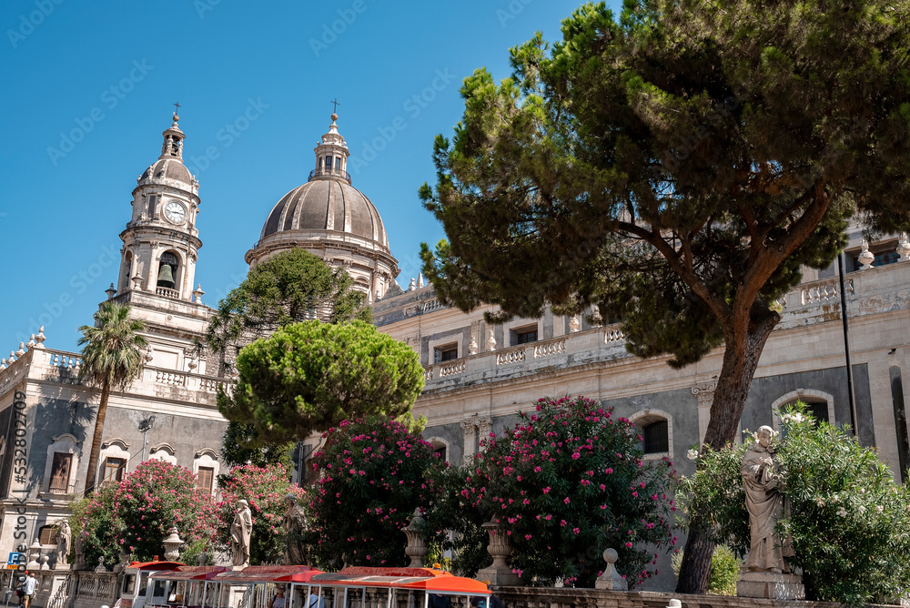 Catalina, Sicily, Italy. August 26, 2022. Bell tower and cupola of Catania baroque cathedral Saint Agata in city. Beautiful famous church with blue sky in background at city during summer.