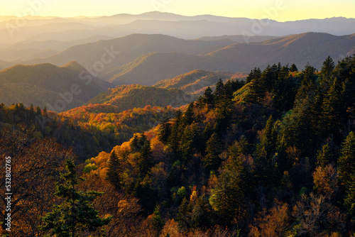 A beautiful autumn mountain scene with sun hitting the mountains at sunset in the Smoky Mountains in North Carolina.  photo