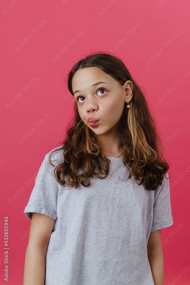 Young beautiful long-haired thoughtful girl with puckered lips looking aside Young beautiful long-haired thoughtful girl with puckered lips looking aside