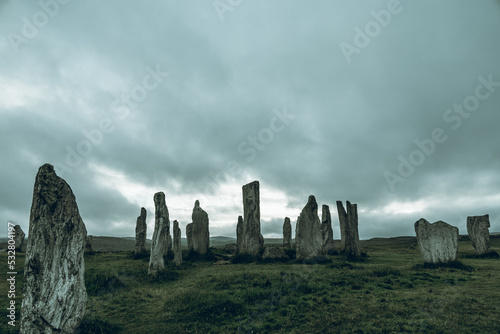 Ancient magic in the Calanais Standing Stones Circle, erected by neolithic men for worship. Celtic traditions in the outer hebrides of Scotland. Touristic attraction. photo
