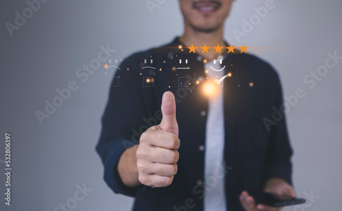 smart businessman use smartphone choosing happy smile face icon. feedback rating and positive customer review experience, satisfaction survey. world mental health day concept. mental health assessment