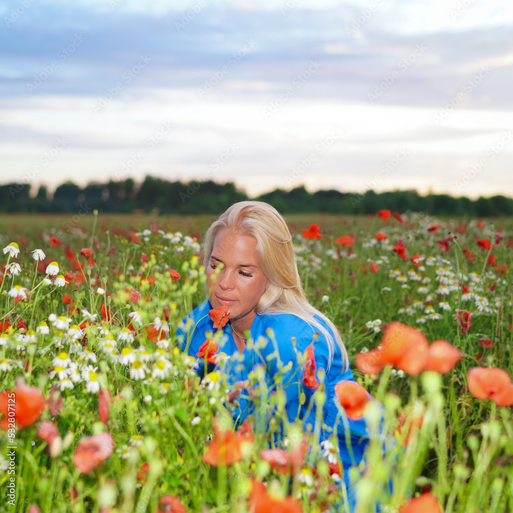 Beautiful girl in poppy field