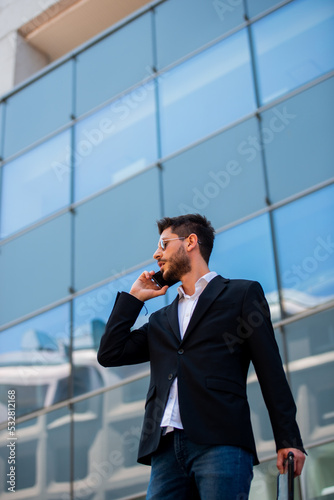 Businessman talking on his phone while standing