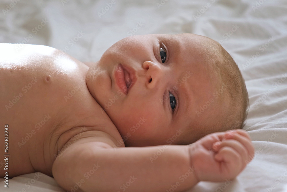Closeup portrait of Newborn baby on white blanket. Soft focus. Infant is lying, yawning. One, two week age. Infant girl waking up on bed at home. New life and growing up concept. Real People. Closeup portrait of Newborn baby on white blanket. Soft focus. Infant is lying, yawning. One, two week age. Infant girl waking up on bed at home. New life and growing up concept. Real People.