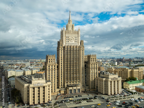 Moscow cityscape within day time. Offices buildings exterior. Building of the Ministry of Foreign Affairs  MFA. Rooftops of residential houses on blue sky, bottom up view coat of arms of the USSR photo