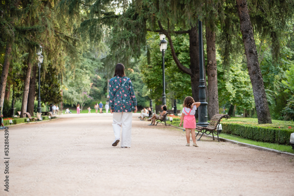 mother and daughter walking in the park mother and daughter walking in the park