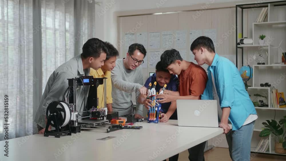 Asian Man With A Laptop And 3D Printing Teaching The Boys Repairing A Cyborg Hand At School
Asian Man With A Laptop And 3D Printing Teaching The Boys Repairing A Cyborg Hand At School