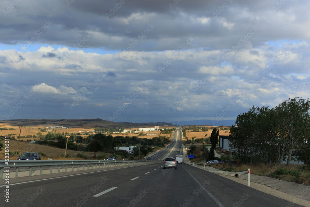 Fototapeta premium Highway wide road, transport and blue sky with clouds on a summer day
