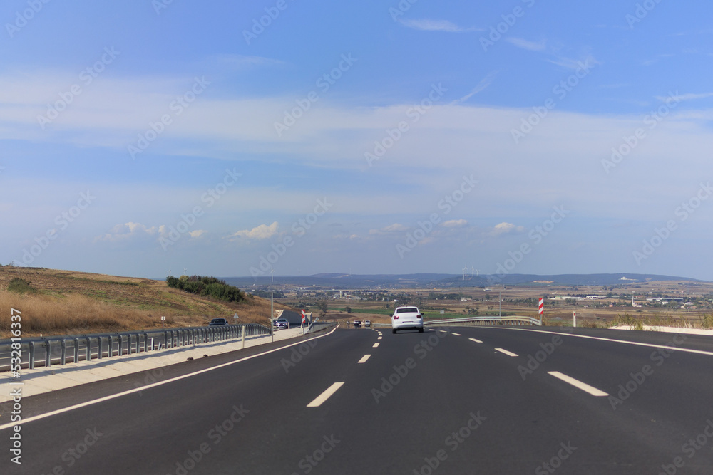 Highway wide road, transport and blue sky with clouds on a summer day