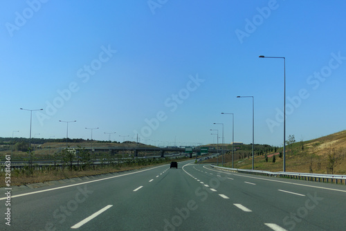 Highway wide road, transport and blue sky with clouds on a summer day © Kozlik_mozlik