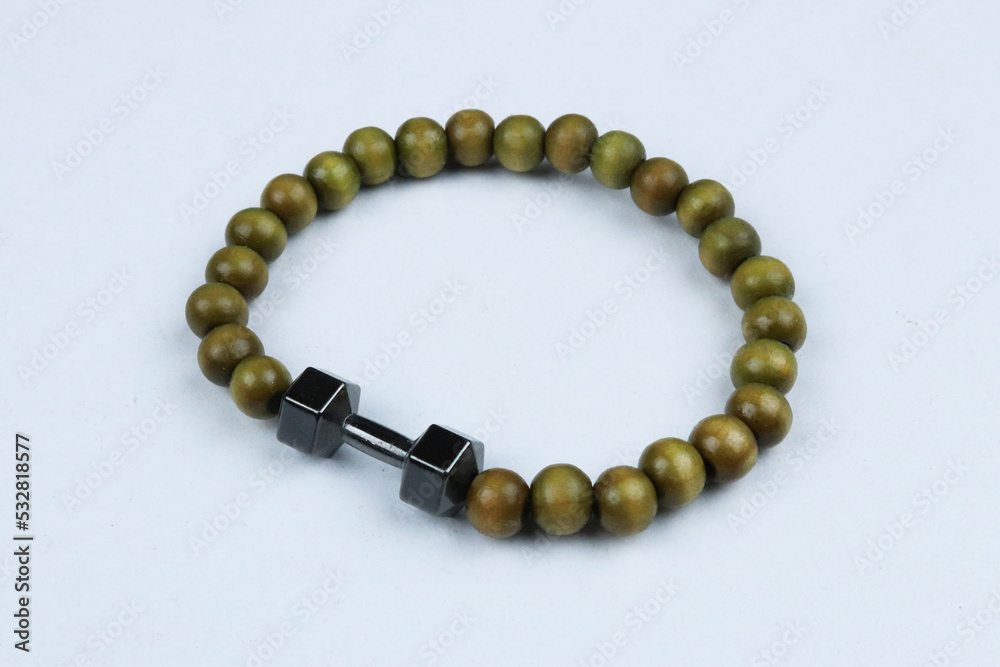 Obraz premium Green bead bracelet with dumbbell symbol