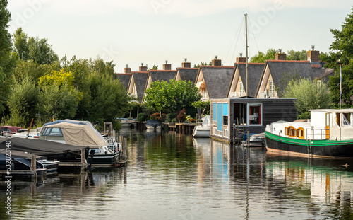 Marina with houses along the water nearby small dutch village Haarlemmerliede in municipality of Haarlemmermeer photo