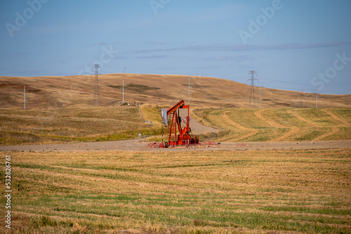 Oil well in rural Alberta Canada pumping oil and gas. photo