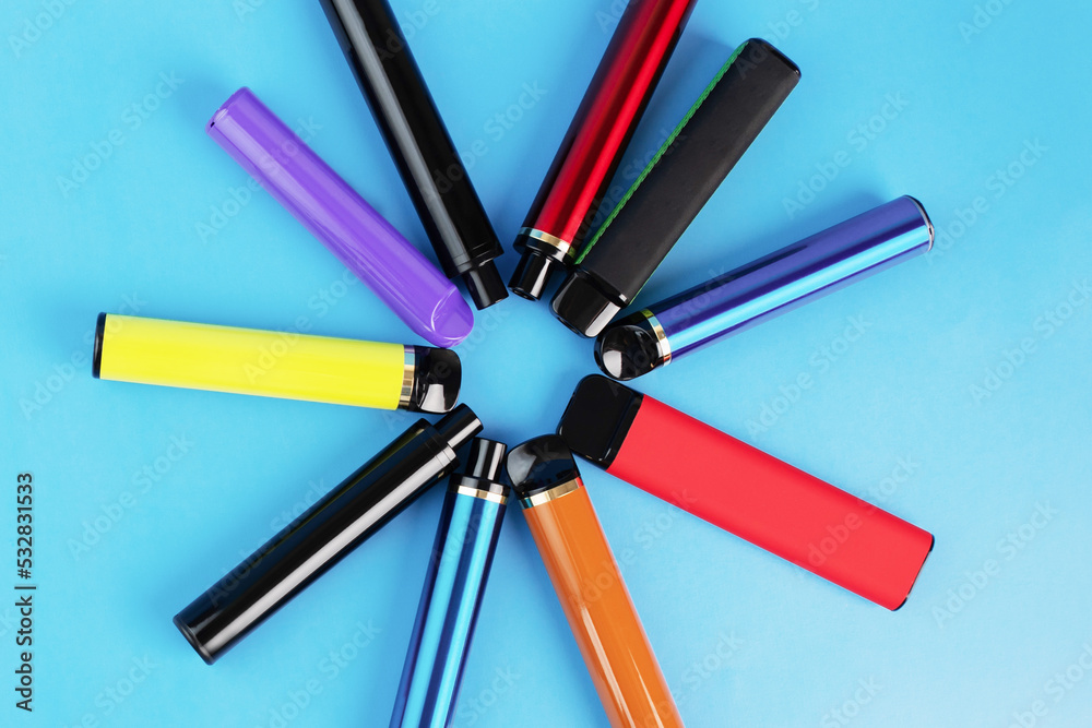 disposable vape, electronic cigarettes, liquid vaporizers, smoking devices on a blue background disposable vape, electronic cigarettes, liquid vaporizers, smoking devices on a blue background