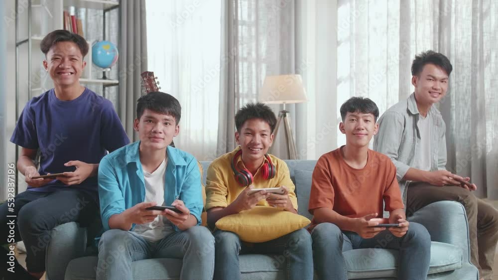 Group Of Young Asian Friends With Musical Instruments Smiling To Camera While Playing Game On Smartphones On A Sofa At Home
Group Of Young Asian Friends With Musical Instruments Smiling To Camera While Playing Game On Smartphones On A Sofa At Home
