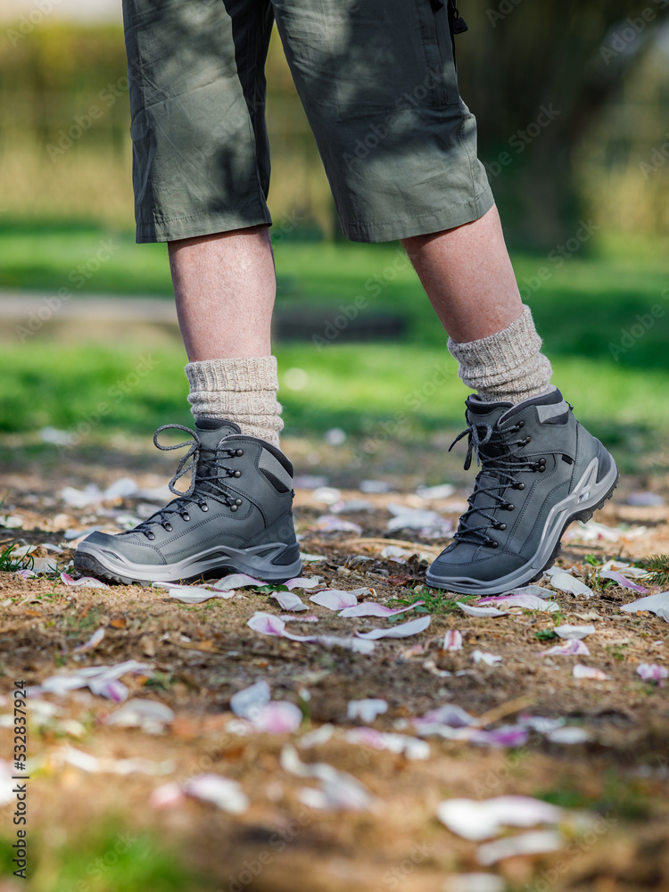 Man walking with elegant brand new hiking boots Man walking with elegant brand new hiking boots