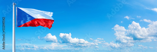 Czech flag waving on a blue sky in beautiful clouds - Horizontal banner