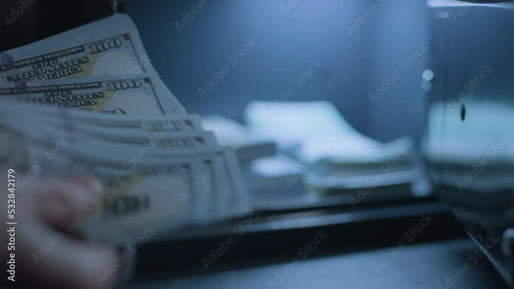 A businessman is counting money with a safe on background. Cash for banking deposit or credit. Euros and dollars savings. Concept of finance safety or investment and profit